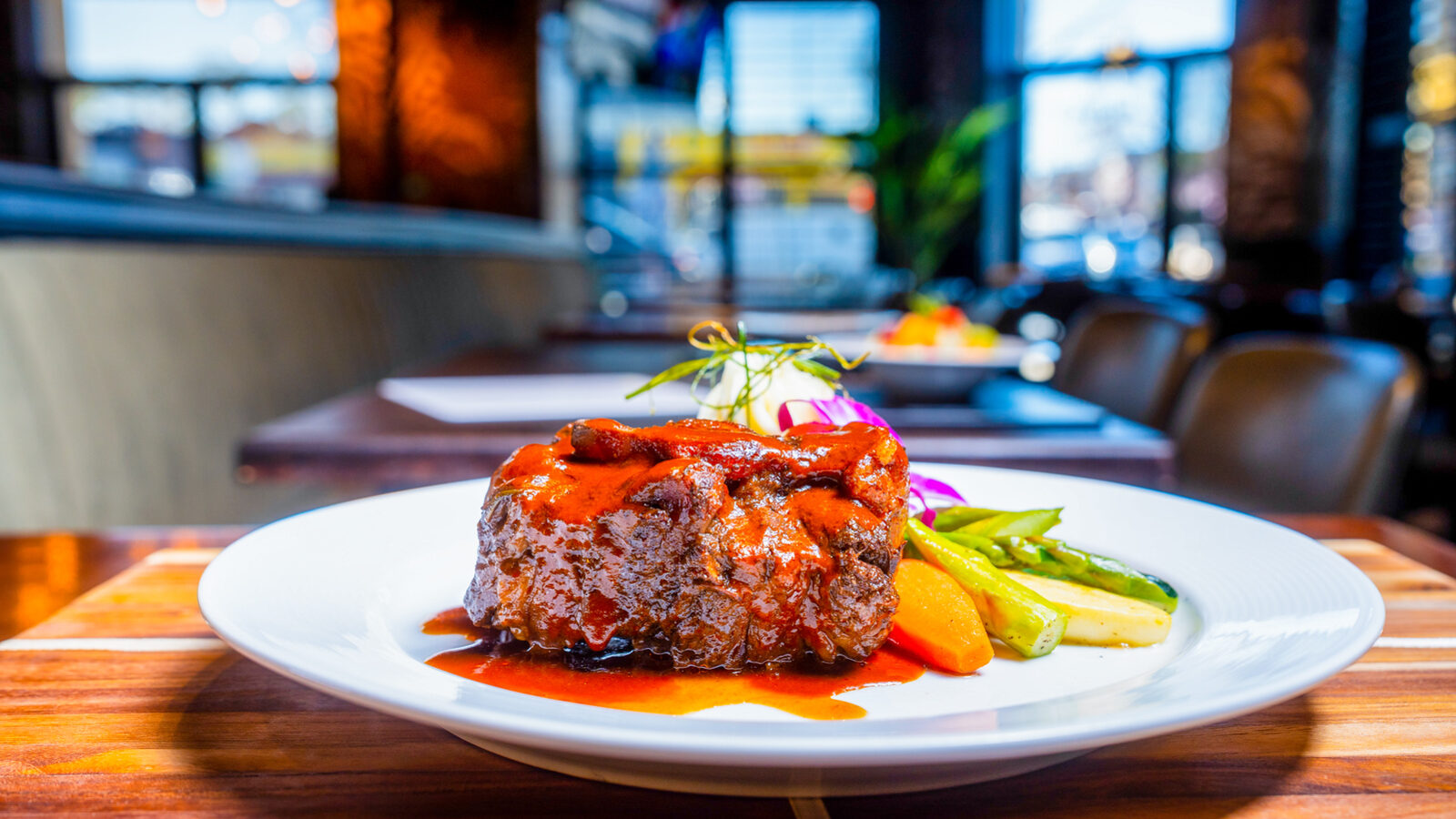 A braised entree plated in the dining room, shot for social media